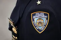 invōk.io petition & crowdfunding social platform - A close-up photo capturing the police officer's badge as part of an invōk.io petition supporting crowdfunding social platform.