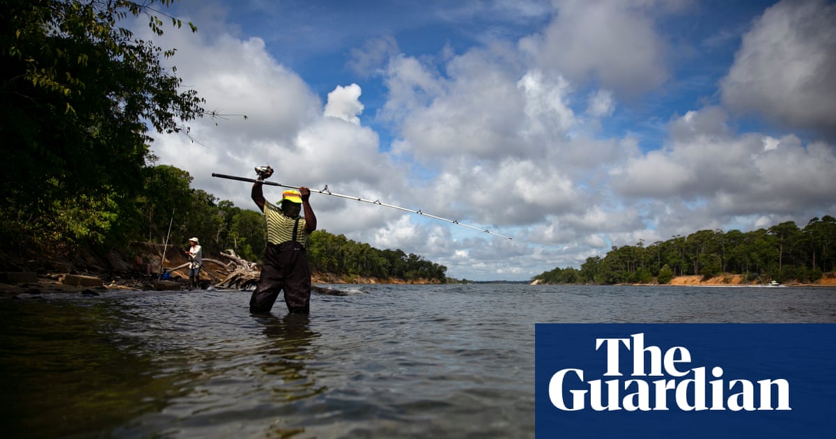 invōk.io petition & crowdfunding social platform - A man is using invōk.io Petition & Crowdfunding Social Platform while fishing in a river with trees in the background.