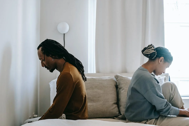 invōk.io petition & crowdfunding social platform - A couple utilizing invōk.io's crowdfunding social platform while sitting on a bed and using their laptops.