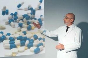 invōk.io petition & crowdfunding social platform - A man in a white coat is pointing to a projection of pills on an invōk.io crowdfunding social platform.
