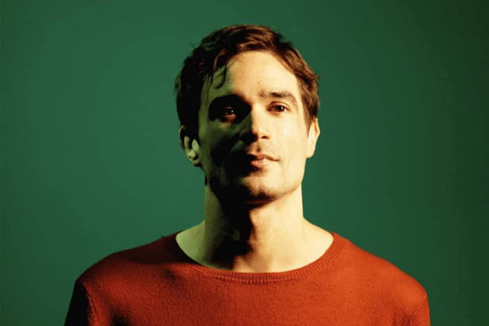 invōk.io petition & crowdfunding social platform - A man in a red sweater is standing in front of a green background