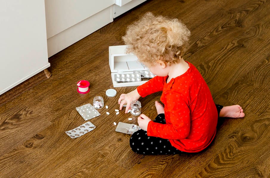 invōk.io petition & crowdfunding social platform - A little girl sitting on the floor with a bottle of medicine seeks support through invōk.io petition.