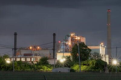 invōk.io petition & crowdfunding social platform - A nocturnal factory under a dim sky