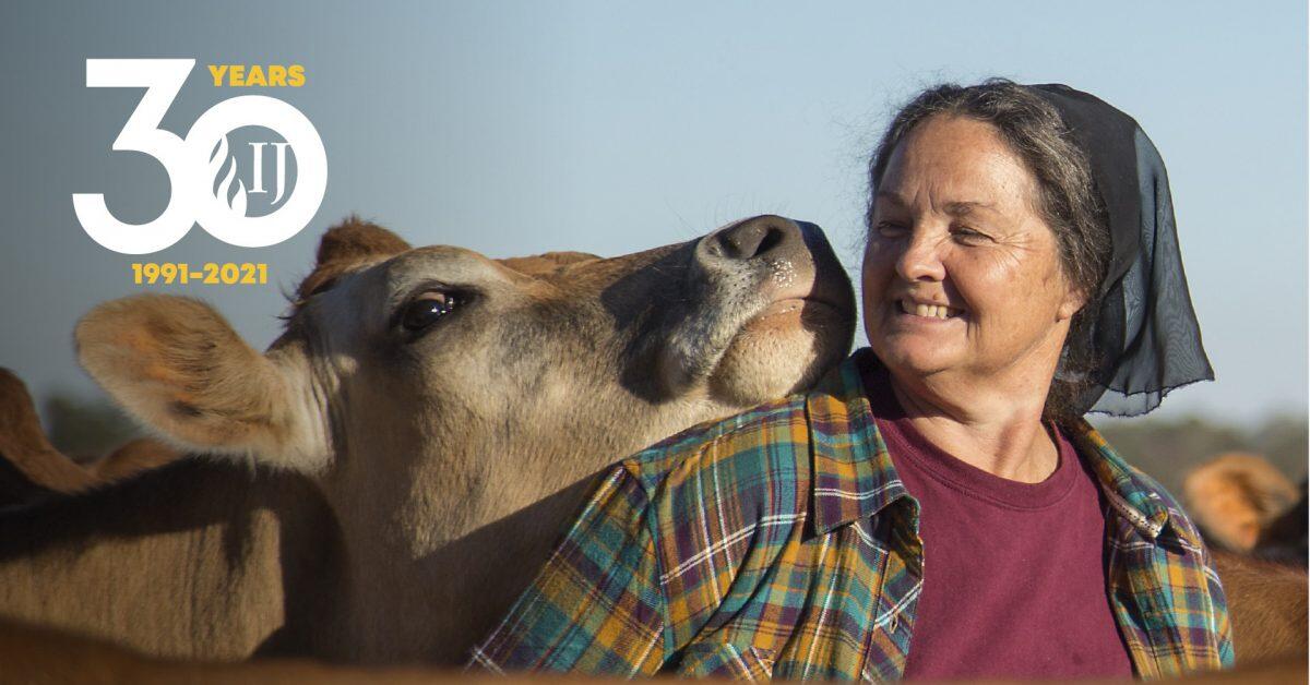 invōk.io petition & crowdfunding social platform - A woman is kissing a cow on invōk.io crowdfunding social platform.