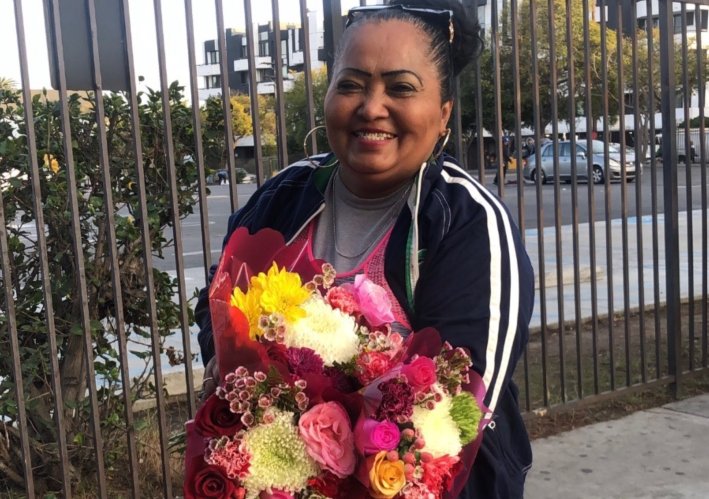 Unbroken Spirit: How a Detained Street Vendor Is Now Aiding Detainees From ICE Facility 2 Emma De Paz holding flowers. Photo via Emma's daughter.