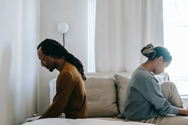 invōk.io petition & crowdfunding social platform - A couple utilizing invōk.io's crowdfunding social platform while sitting on a bed and using their laptops.