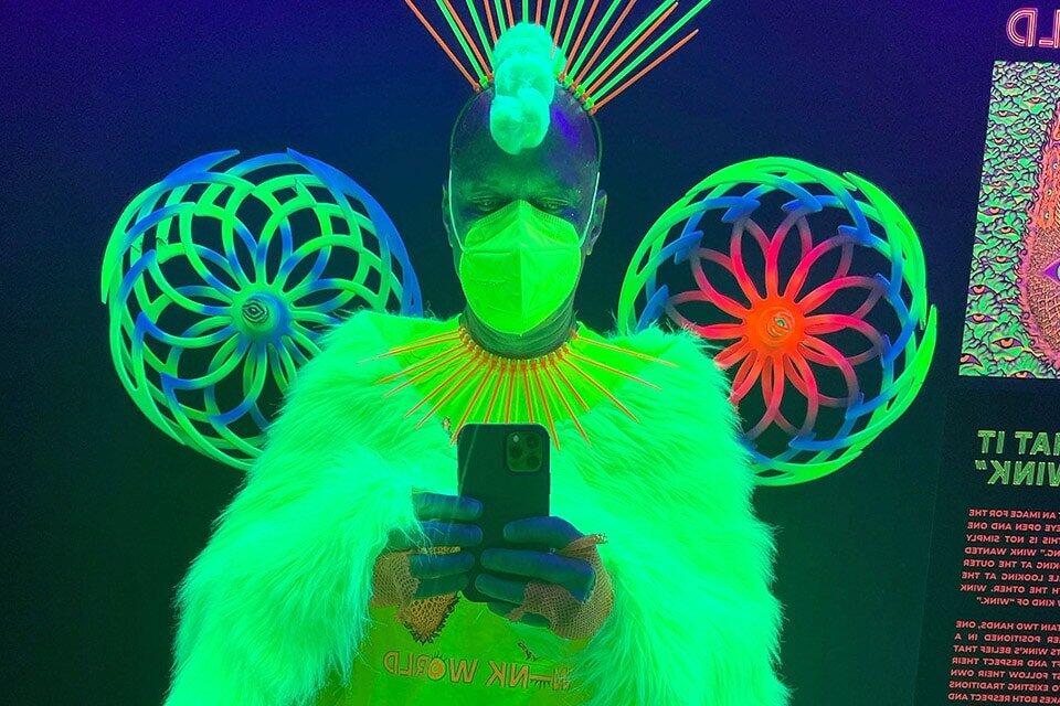 invōk.io petition & crowdfunding social platform - A woman in a green costume using invōk.io to take a selfie.|invōk.io petition & crowdfunding social platform - invōk.io: crowdfunding
