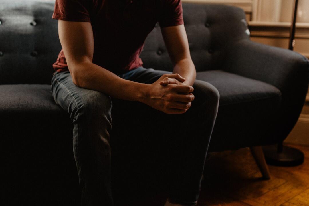 invōk.io petition & crowdfunding social platform - A man using the invōk.io platform on a couch in a dark room.