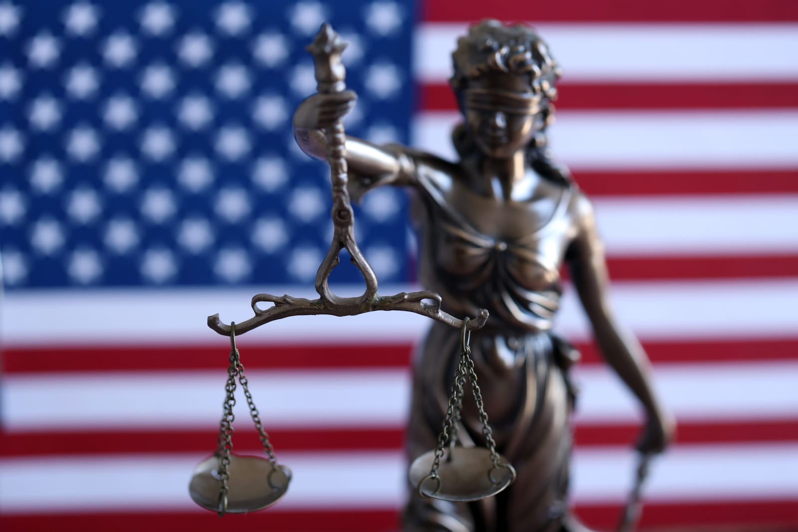 Invok.io - sentancing Project - 99168020_american-constitution-law-and-legal-system-statue-of-lady-justice-with-scales-of-justice-with-american-flag