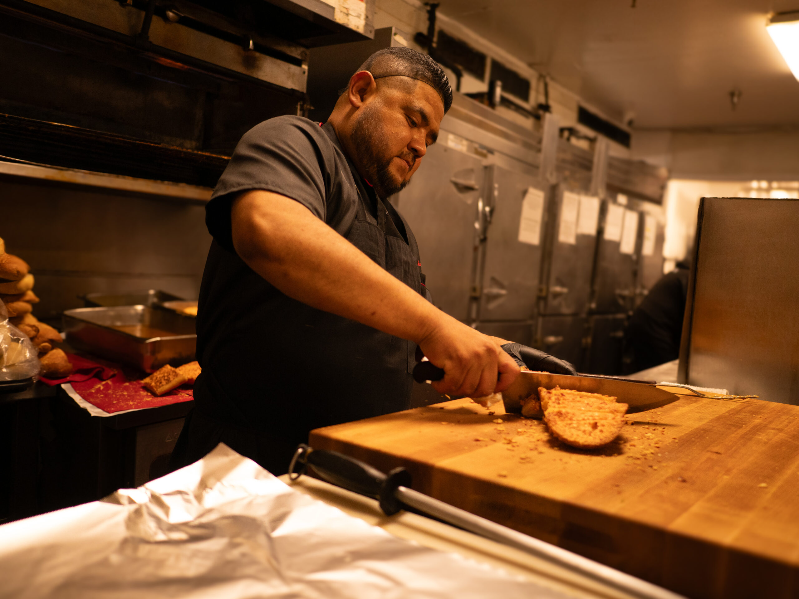 These Nine L.A. Dishwashers Are the Real Heroes of Your Favorite Restaurants 6 a man chops food on a wooden cutting board